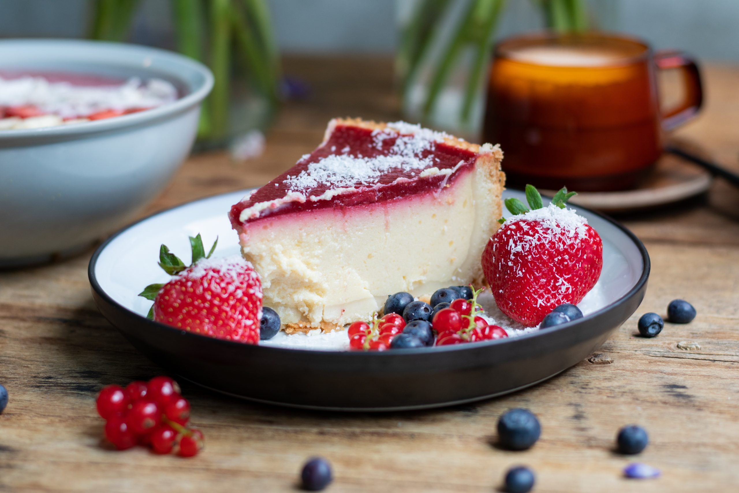 A closeup shot of cheesecake with jelly decorated with strawberries and berries